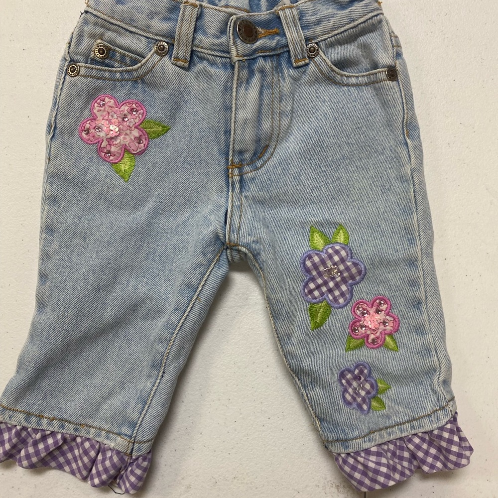 Lipstick brand blue Jean with purple fringe bottom and flower appliqués size 3T